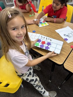 Child showing book with stars